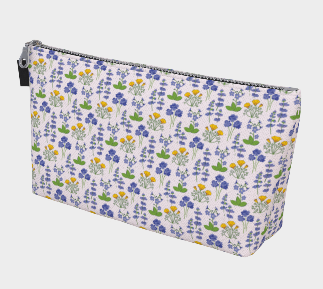 Large Carry All Make Up Bag with denim lining. Light wildflower floral pattern. Front view.