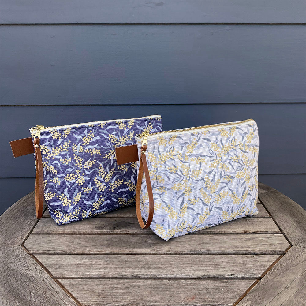 Large Carry All Make Up Bag with denim lining. Mimosa Tree botanical pattern. Shown on table.