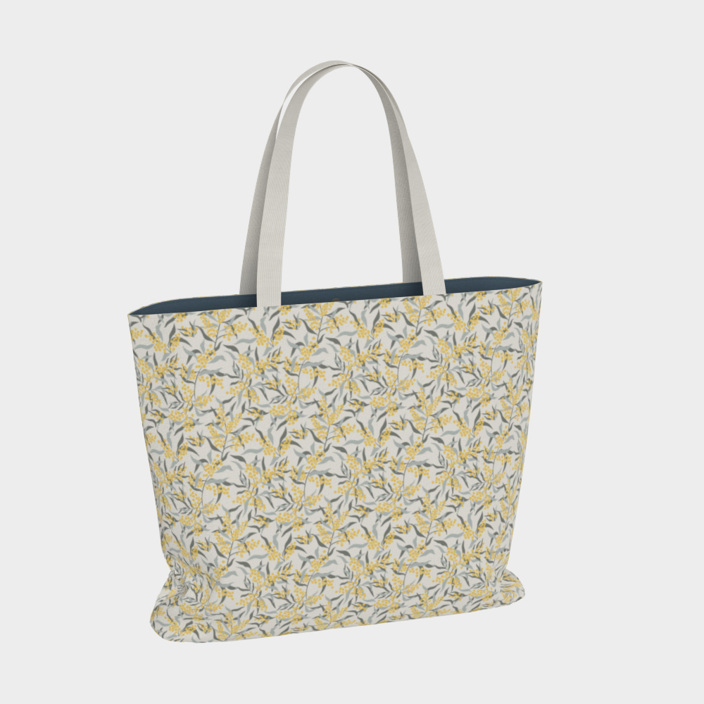 Oversized Fully Lined Cotton Tote Bag with sturdy 1 ½ inch strap. Floral botanical pattern featuring sage green leaves and yellow blossoms on a creamy white background. Back view.