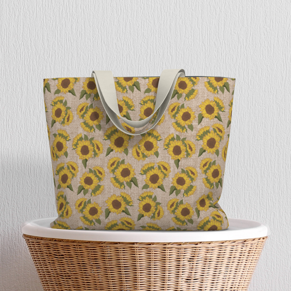 Oversized Fully Lined Cotton Tote Bag with sturdy 1 ½ inch strap. Sunflower floral pattern. Shown on wicker basket.