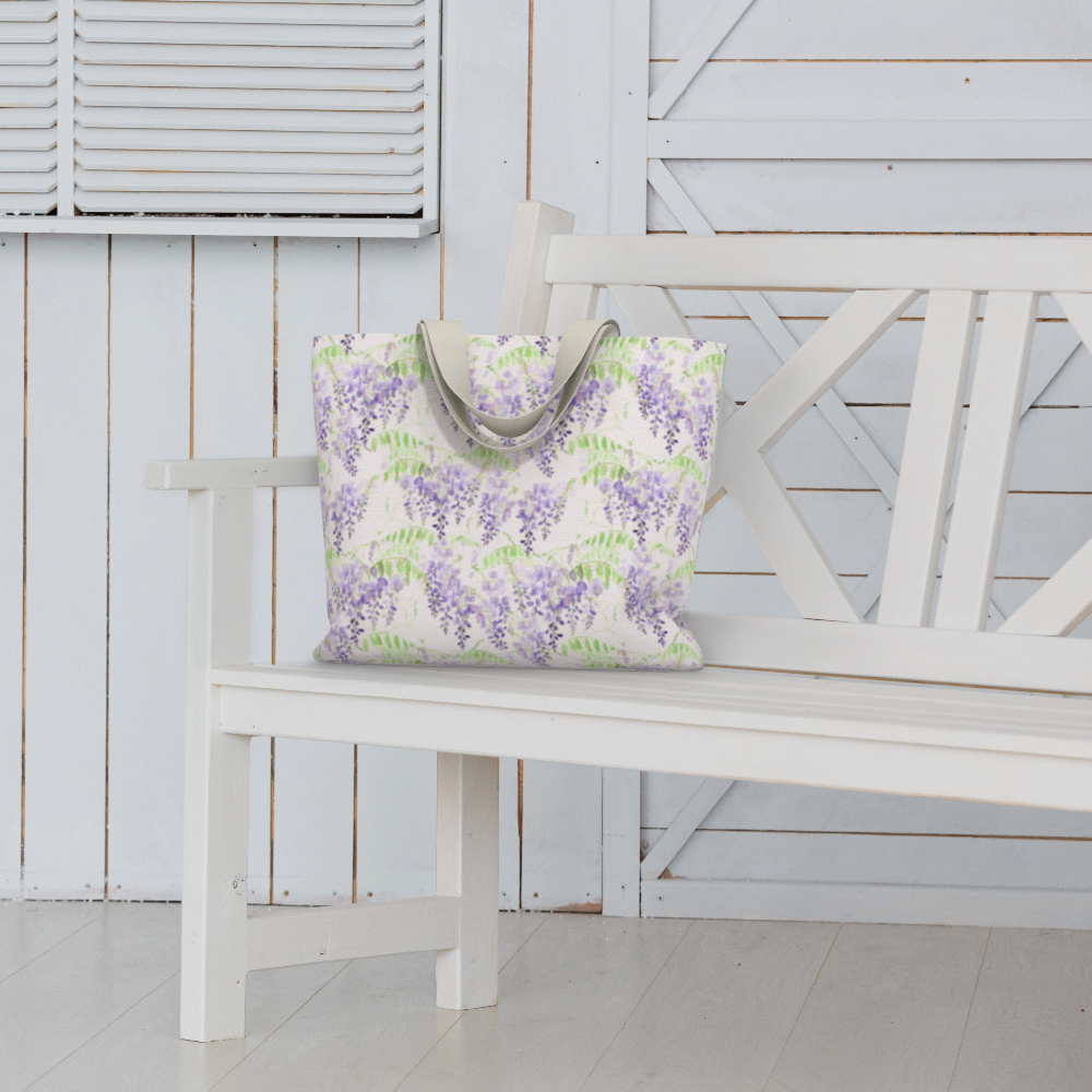 Oversized Fully Lined Cotton Tote Bag with sturdy 1 ½ inch strap. Purple wisteria floral pattern. Shown on white bench.