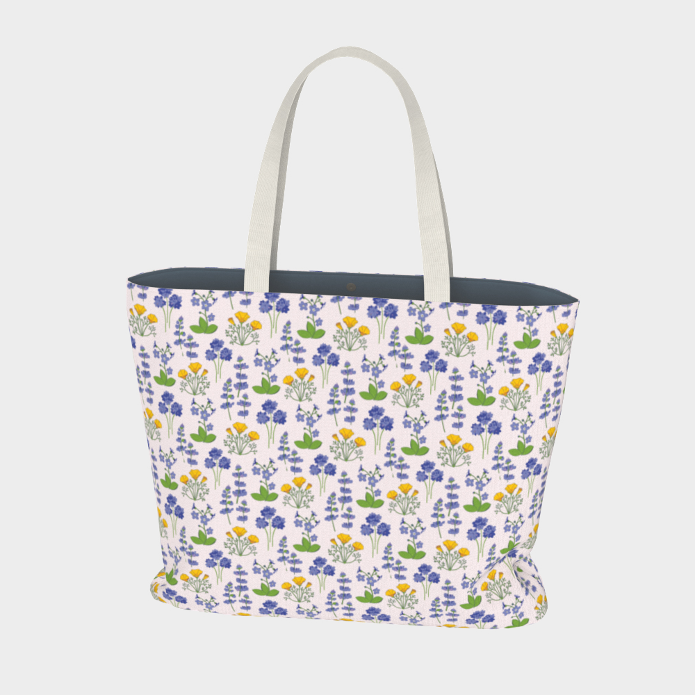 Oversized Fully Lined Cotton Tote Bag with sturdy 1 ½ inch strap. Wildflower pattern featuring California poppies and wild lupine on light pink background. Front View.