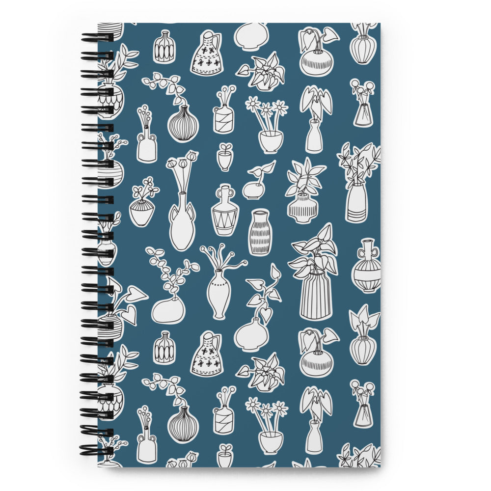 Bullet journal spiral notebook with plant doodle pattern in blue. Front cover.