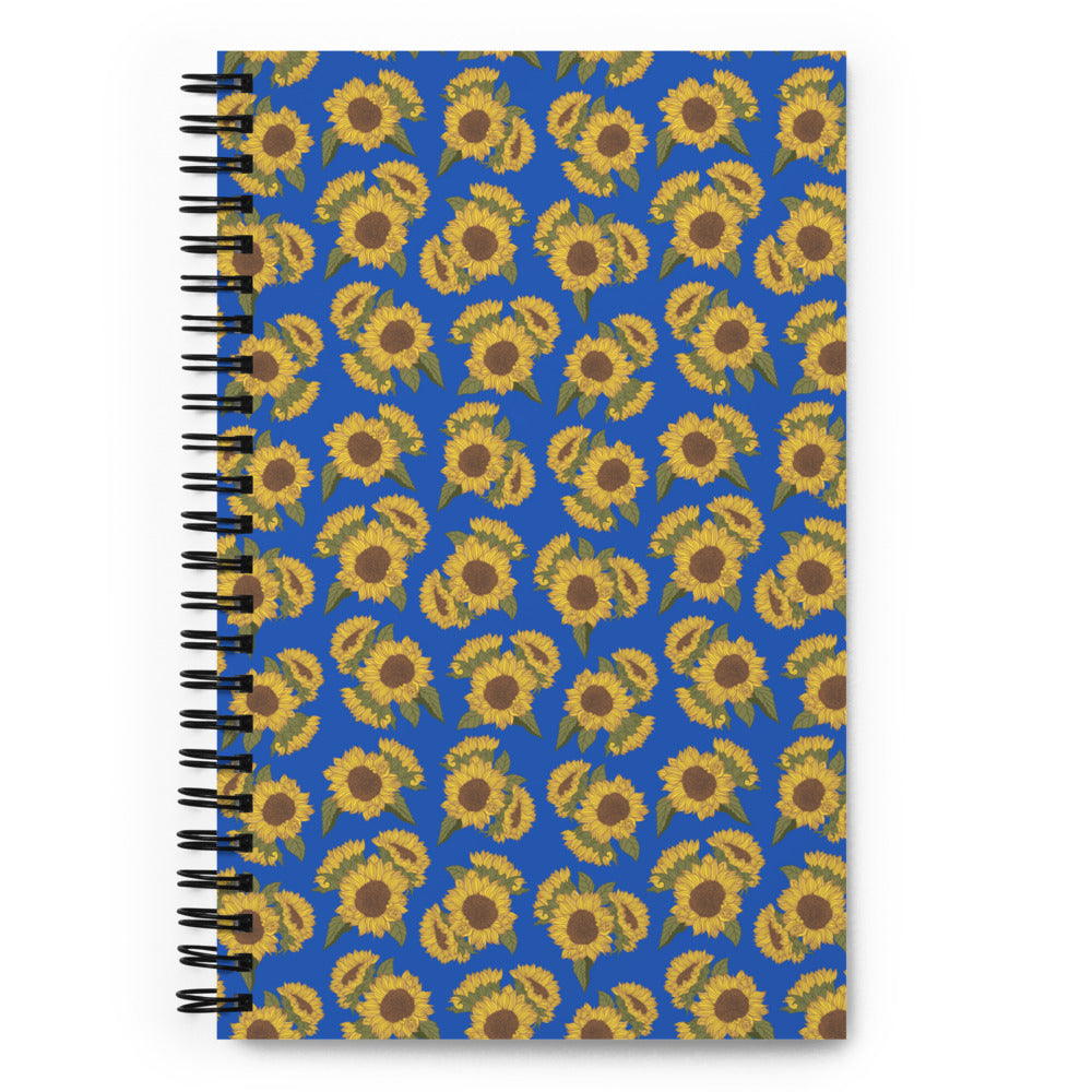 Bullet journal spiral notebook with ditsy sunflower pattern on royal blue. Front cover.