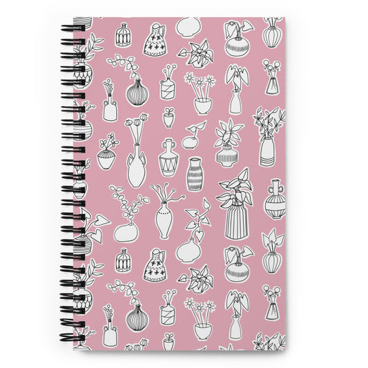 Bullet journal spiral notebook with plant doodle pattern in pink. Front cover. 