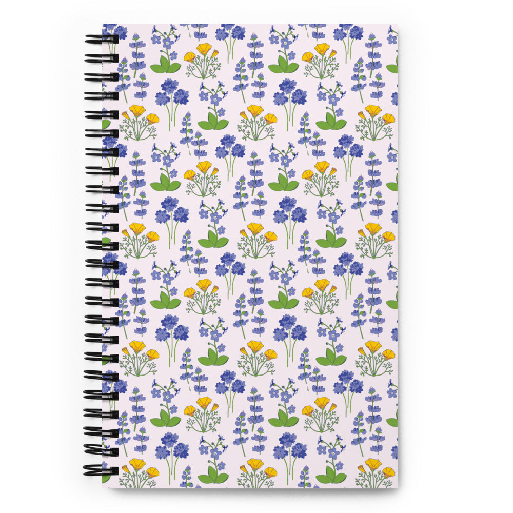 Bullet journal spiral notebook with wildflower pattern on a light background. Front cover. 